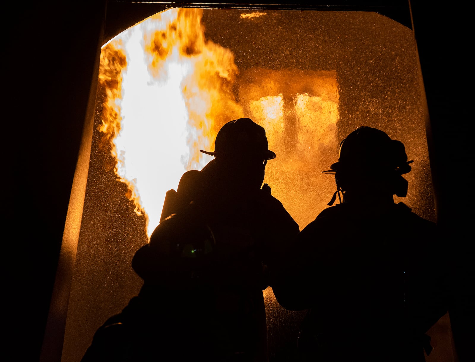 Dayton International Airport firefighters work their way into a mock-up aircraft’s burning fuselage during training Oct. 5 at Wright-Patterson Air Force Base. The training included knocking down the fire and gaining fuselage access for rescue. (U.S. Air Force photo by R.J. Oriez)