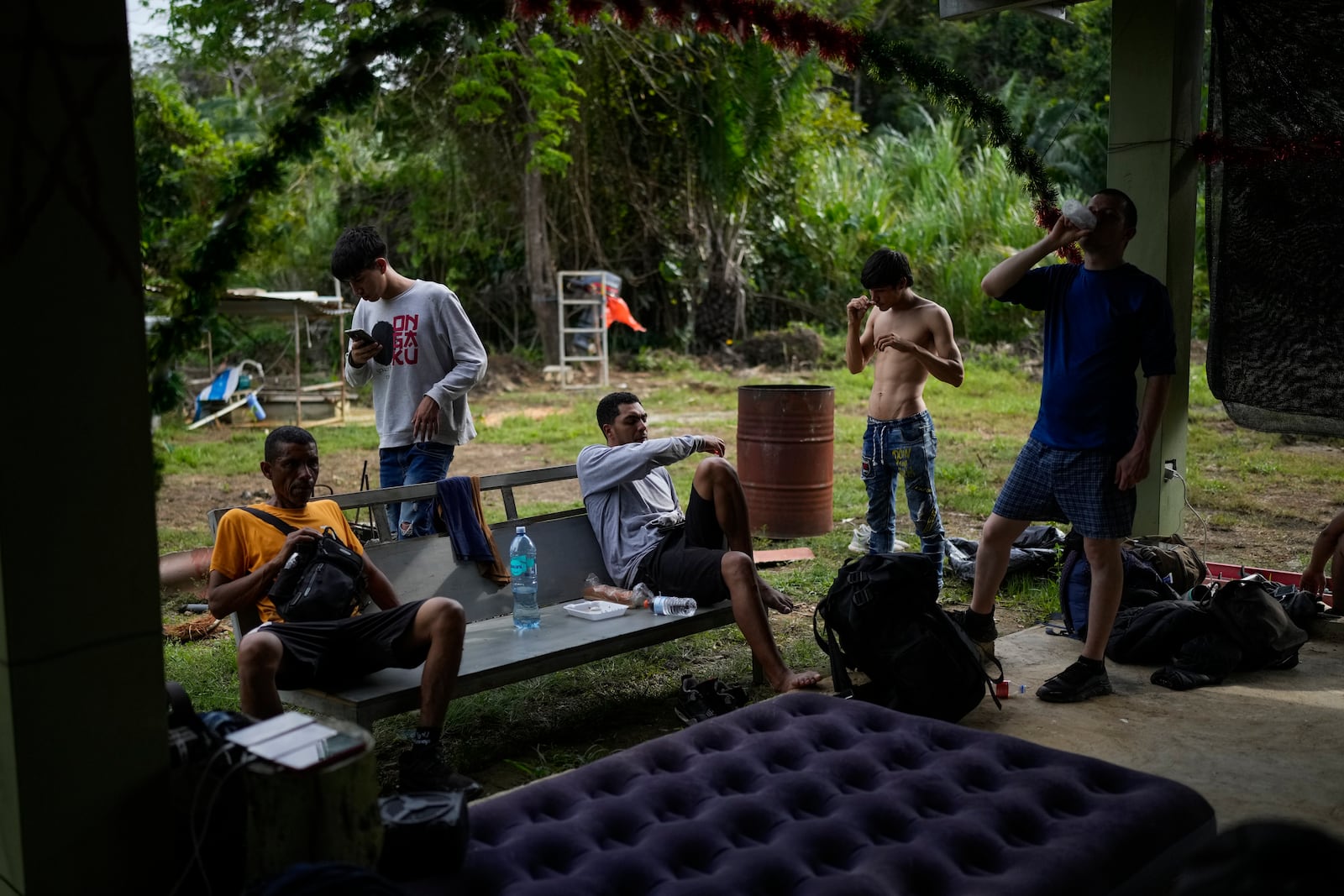 Venezuelan migrants settle in to spend the night in Puerto Carti, on Panama's Caribbean coast, Saturday, Feb. 22, 2025, where they plan to board boats to Colombia after turning back from southern Mexico where they gave up hopes of reaching the U.S. amid President Trump's crackdown on migration. (AP Photo/Matias Delacroix)