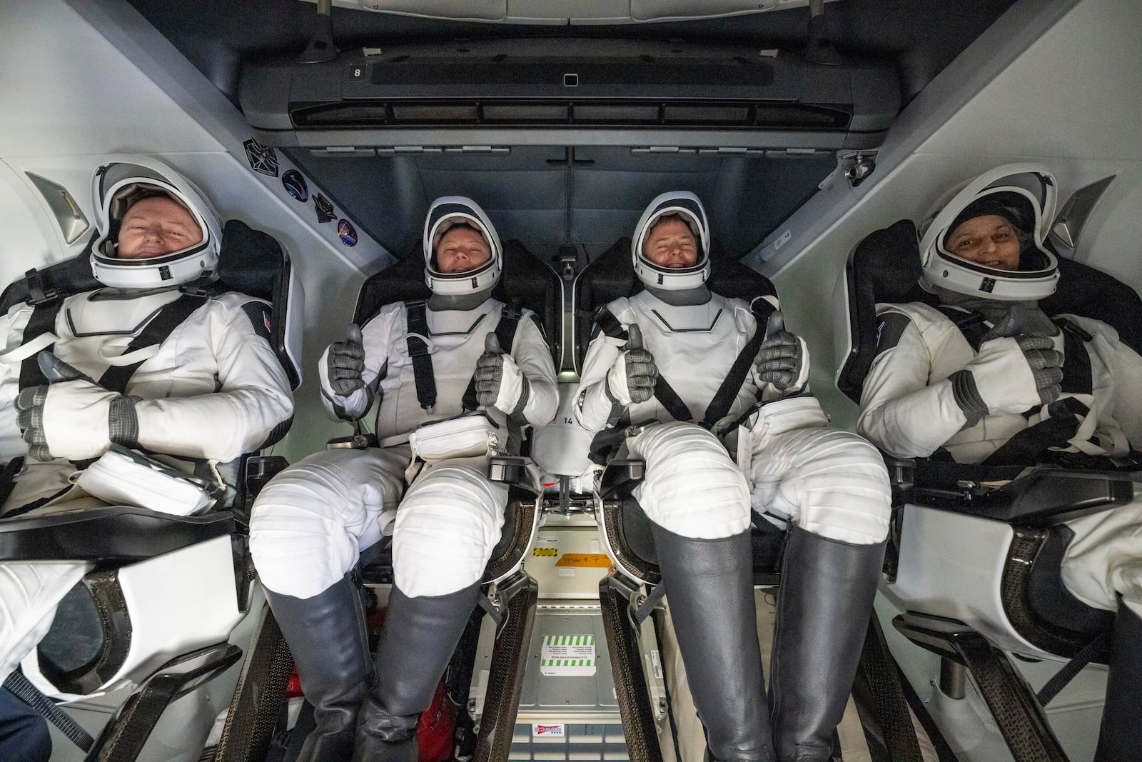 From left, NASA astronaut Butch Wilmore, Russia’s Alexander Gorbunov, and NASA astronauts Nick Hague and Suni Williams sit inside a SpaceX capsule onboard the SpaceX recovery ship Megan after landing in the water off the coast of Florida, Tuesday, March 18, 2025. (Keegan Barber/NASA via AP)