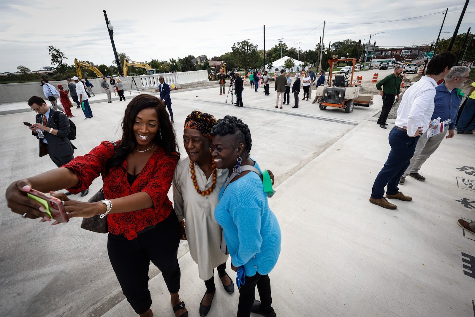 From left, Nia Davis, Audrey Davis and Jackie Ewings, all from Dayton, take a selfie on the new Third Street Bridge after the ribbon cutting. JIM NOELKER/STAFF