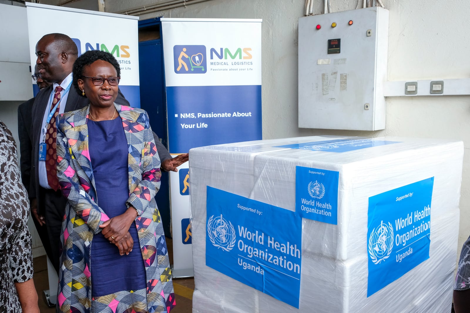 FILE - Uganda's Minister of Health Jane Ruth Aceng receives boxes containing one of three candidate vaccines against the Sudan strain of the Ebola virus, in Entebbe, Uganda, on Dec. 8, 2022. According to Uganda's Ministry of Health the country has received 1200 doses of vaccines from the World Health Organization to be used in an upcoming Ebola vaccine trial. (AP Photo/Hajarah Nalwadda, File)