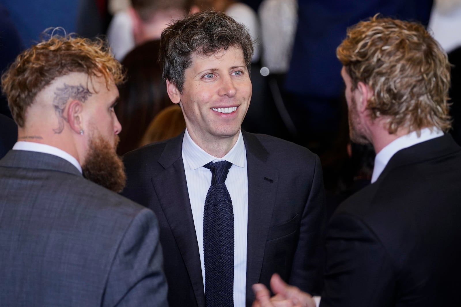 Open AI CEO Sam Altman, center, speaks with boxer Jake Paul and wrestler Logan Paul in Emancipation Hall at the 60th Presidential Inauguration, Monday, Jan. 20, 2025, at the U.S. Capitol in Washington. (Al Drago/Pool Photo via AP)