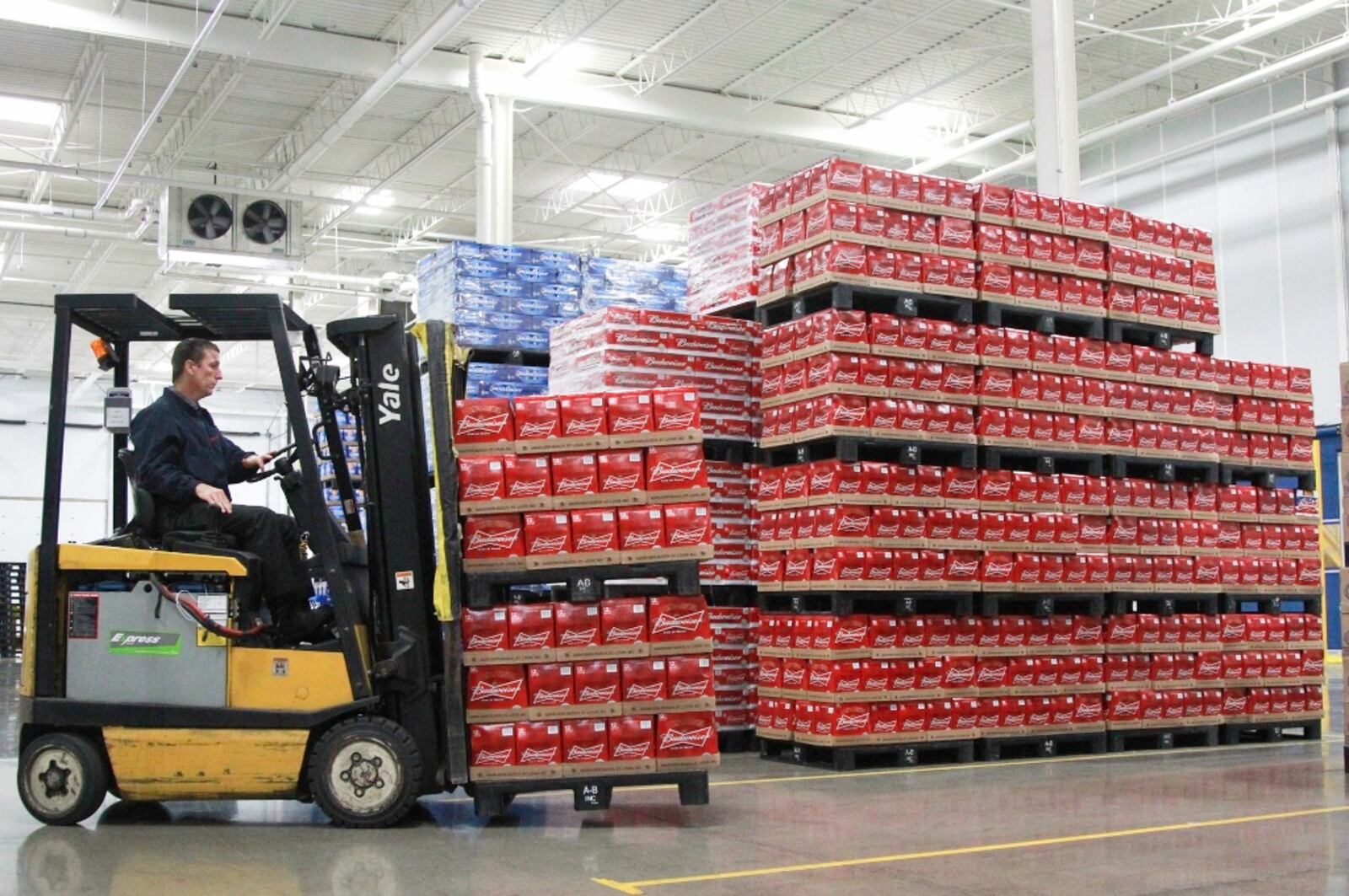 A warehouse operations worker at Heidelberg Distributing moves pallets of beer in July 2013 inside the company’s then-new distribution center in the former Cooper Tire building in Moraine. FILE PHOTO BY CHRIS STEWART / STAFF