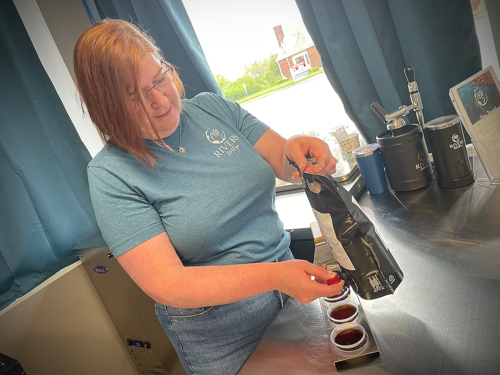 Fifty5 Rivers Cold Brew is located at 644 N. Broad St. in Fairborn. Pictured is owner Lynne Mowery pouring cold brew samples. NATALIE JONES/STAFF