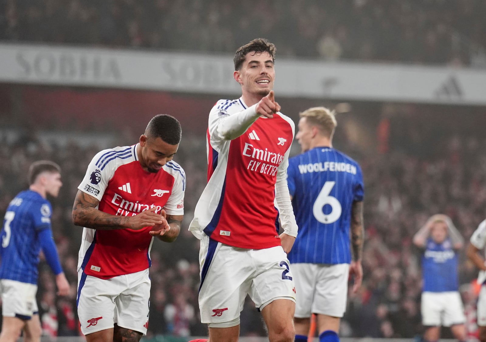 Arsenal's Kai Havertz, center, celebrates after scoring the opening goal during the English Premier League soccer match between Arsenal and Ipswich at the Emirates Stadium in London, England, Friday, Dec. 27, 2024. (John Walton/PA via AP)