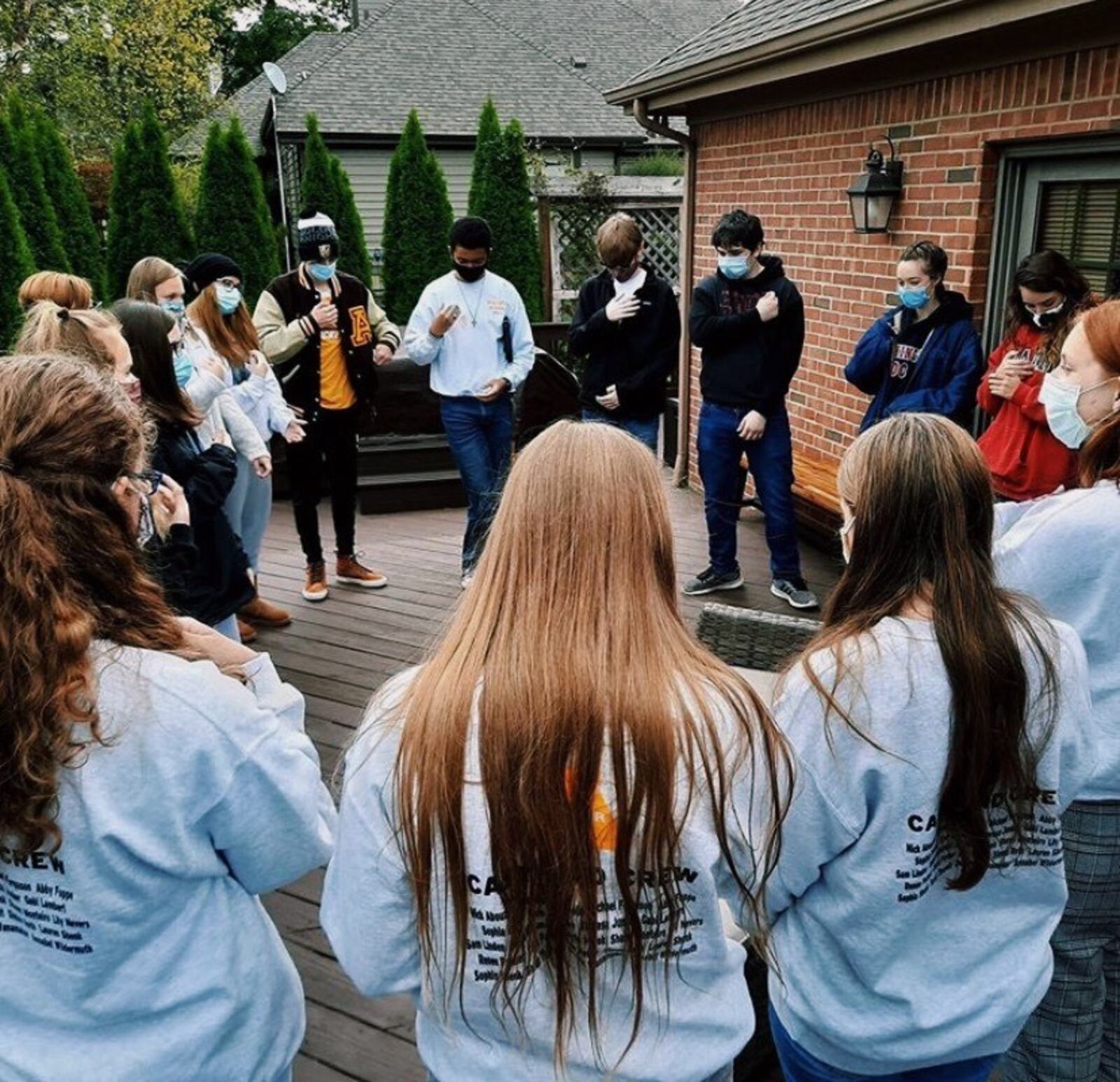 Alter High School's Castle Players filmed the virtual-only performance of "Proof" in the back yard of a cast member. They are praying here before a taping. CONTRIBUTED