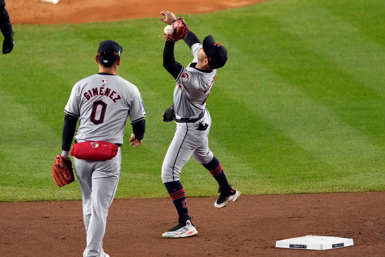 Cleveland Guardians shortstop Brayan Rocchio misses catching a pop fly by New York Yankees' Aaron Judge during the first inning in Game 2 of the baseball AL Championship Series Tuesday, Oct. 15, 2024, in New York. Rocchio was charged with an error. (AP Photo/Seth Wenig)