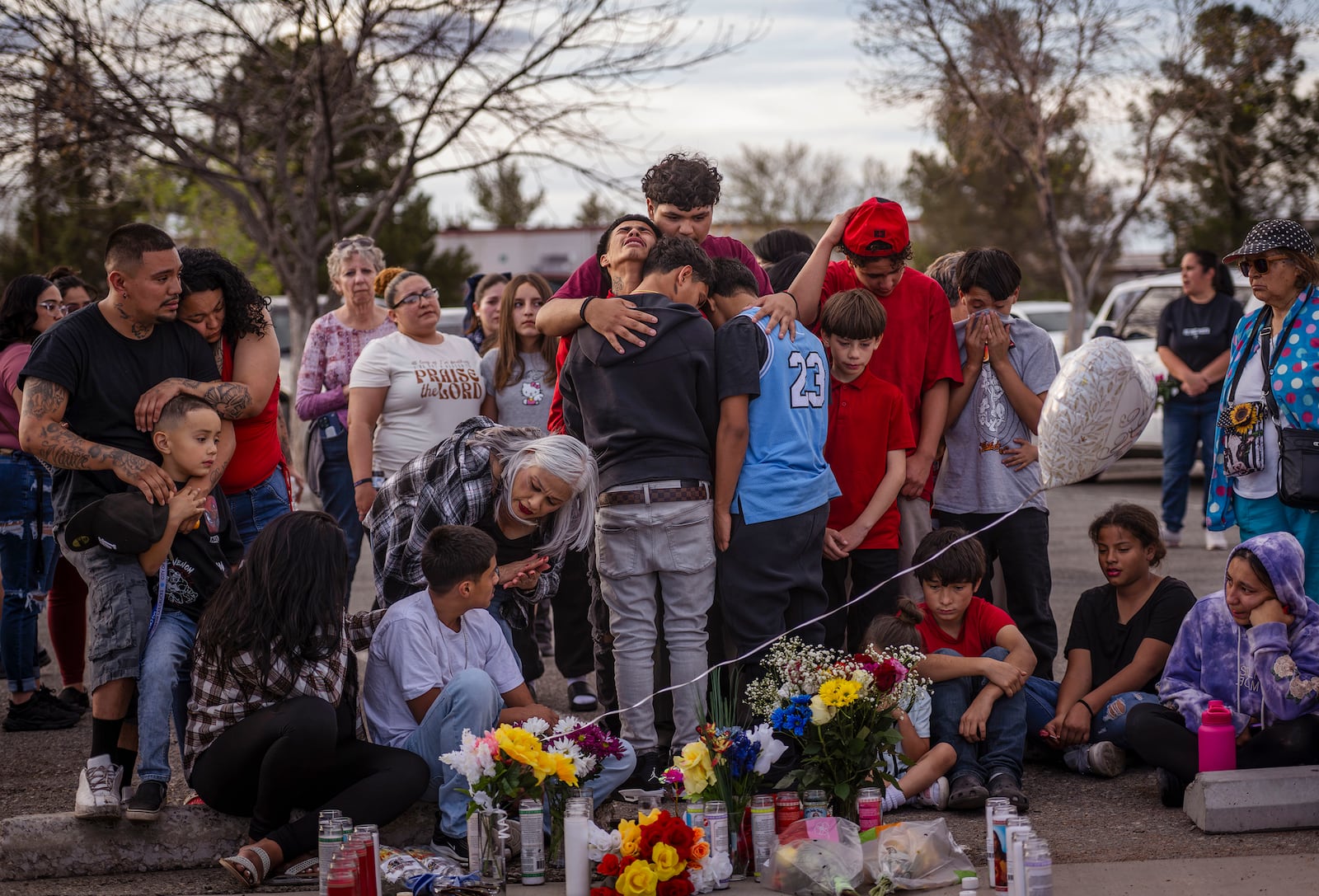 Family members of victim Jason Gomez mourn during a vigil at Young Park in Las Cruces, N.M., on Sunday, March 23, 2025. (Chancey Bush/The Albuquerque Journal via AP)