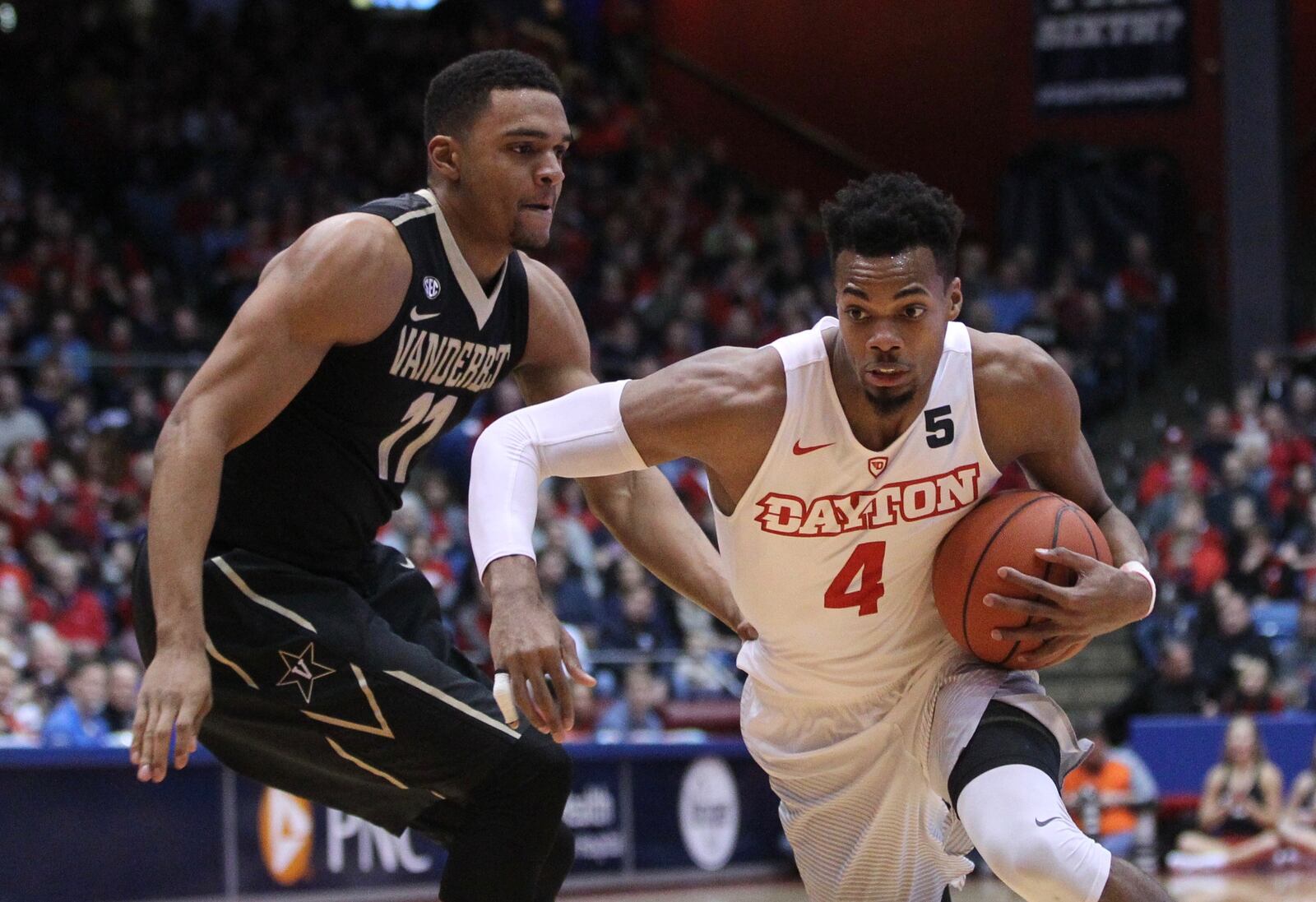 Dayton’s Charles Cooke, right, drives against Vanderbilt’s Jeff Roberson on Wednesday, Dec. 21, 2016, at UD Arena. David Jablonski/Staff