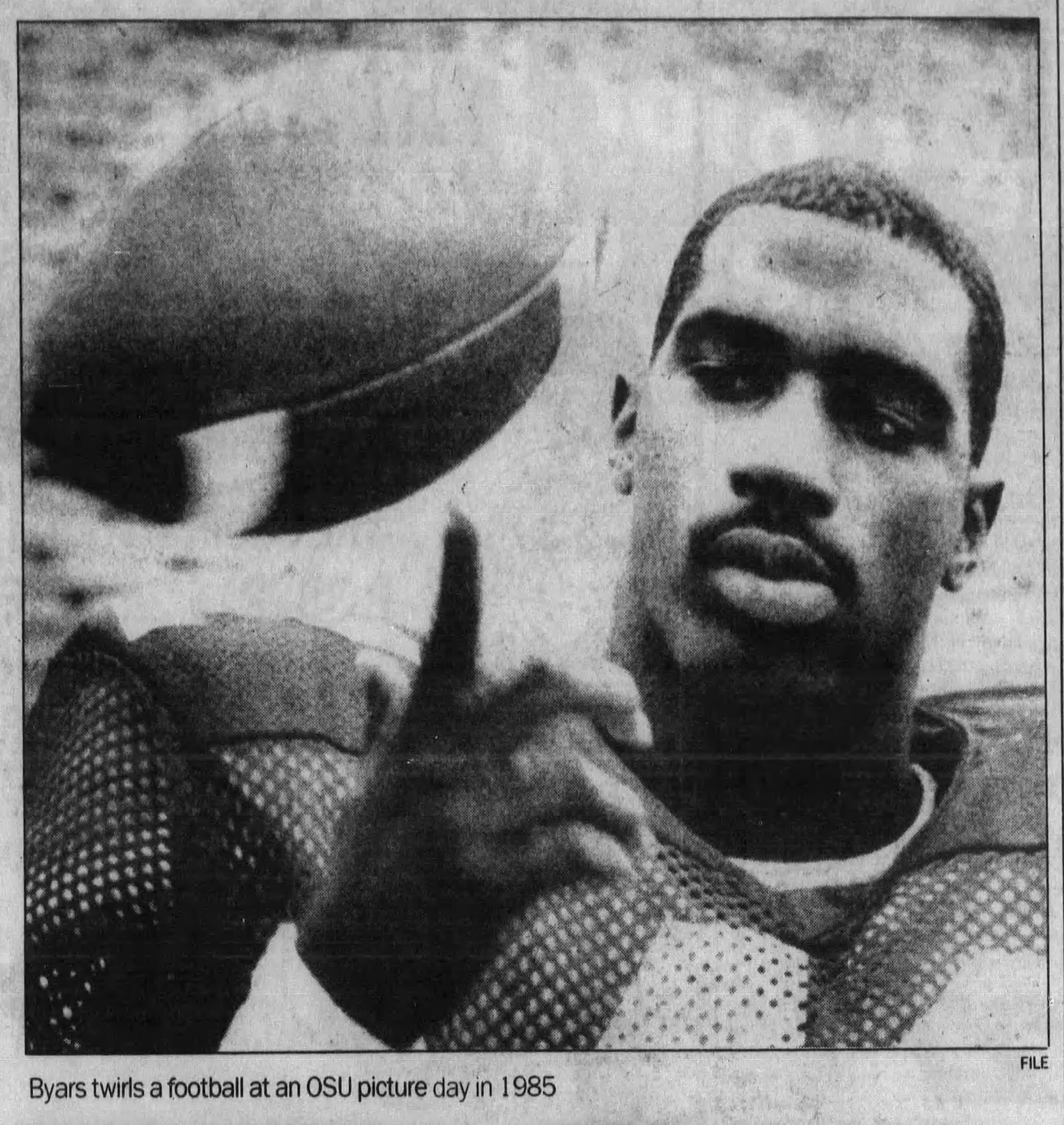 Keith Byars twirls a football at an Ohio State picture day in 1985. DAYTON DAILY NEWS ARCHIVES.