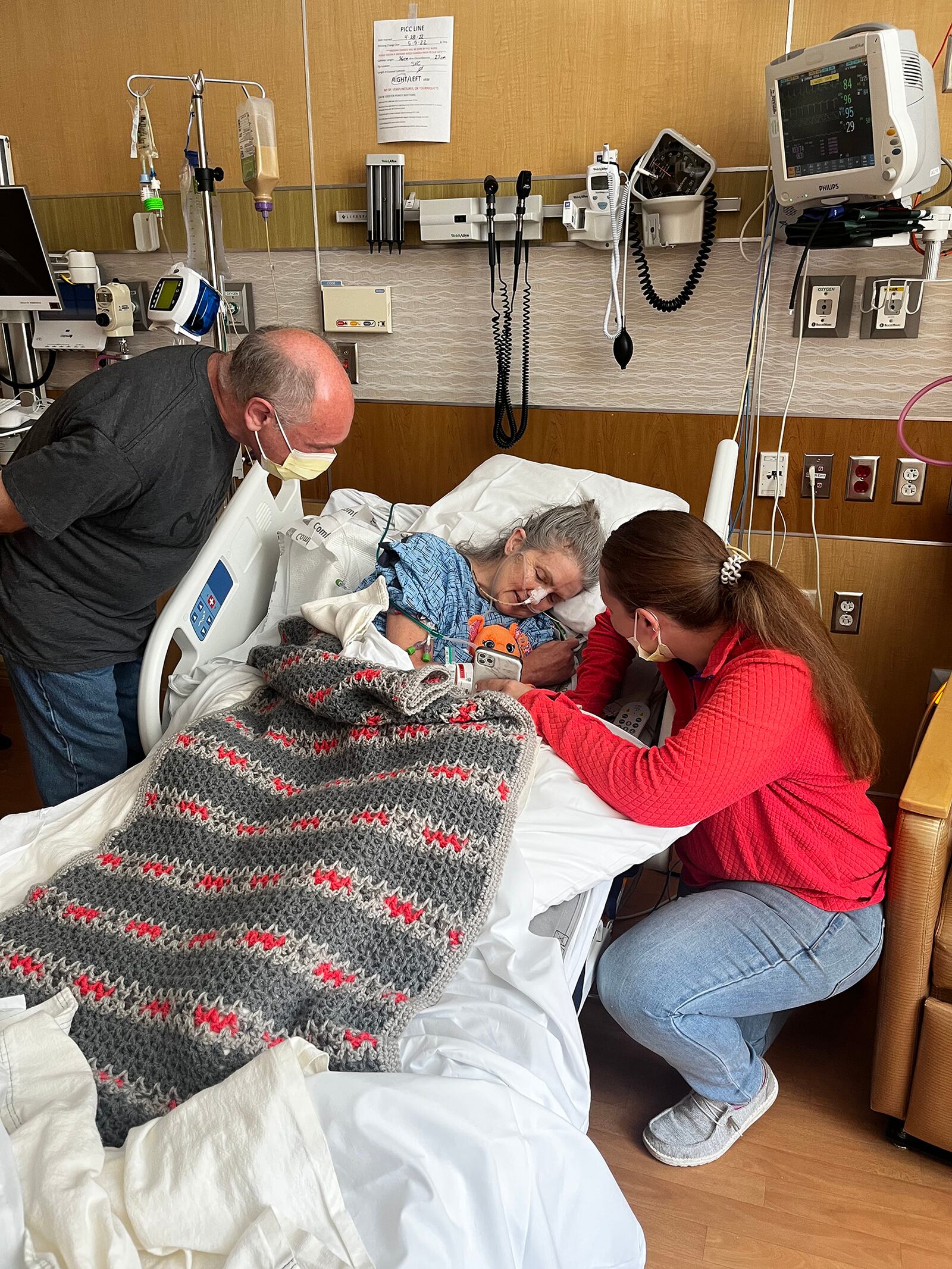 Terri Lininger shortly after waking up at Soin Medical Center last year. She collapsed in the shower and suffered a global brain injury. She is shown with her husband Steve and daughter Jules. CONTRIBUTED