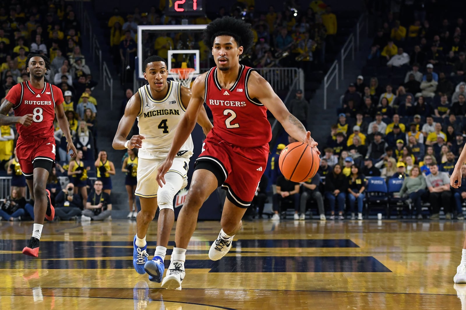 Rutgers guard Dylan Harper, front, dribbles in front of Michigan guard Nimari Burnett during the first half of an NCAA college basketball game, Thursday, Feb. 27, 2025, in Ann Arbor, Mich. (AP Photo/Jose Juarez)