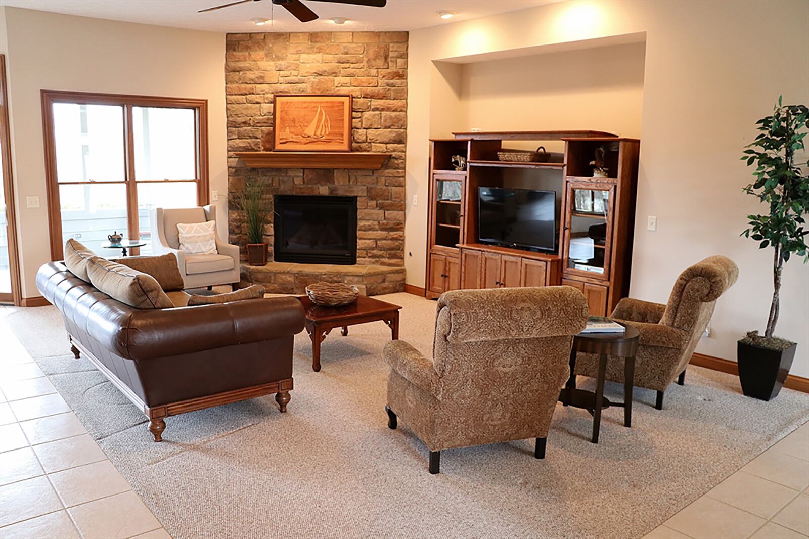 A stone, gas fireplace can be enjoyed from all the main social areas of this split floor plan ranch. CONTRIBUTED PHOTO BY KATHY TYLER