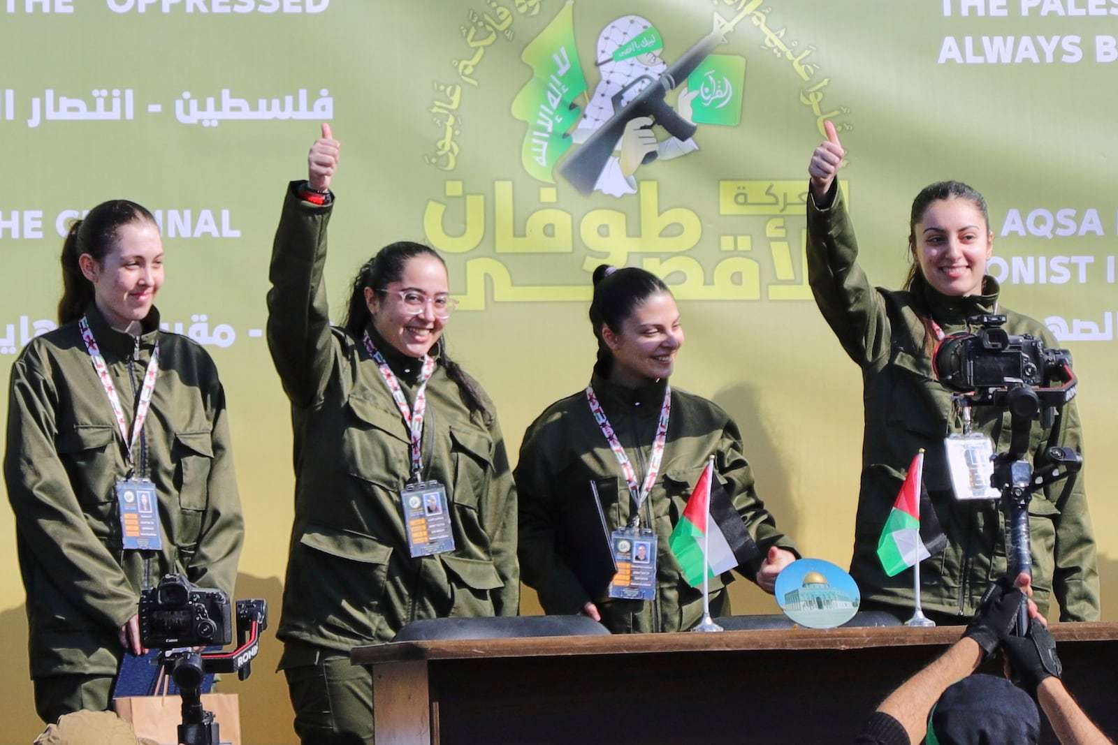 Israeli female soldier hostages wave and react at a Palestinian crowd before being handed over to the Red Cross in Gaza City, Saturday, Jan. 25, 2025. (AP Photo/Abed Hajjar)