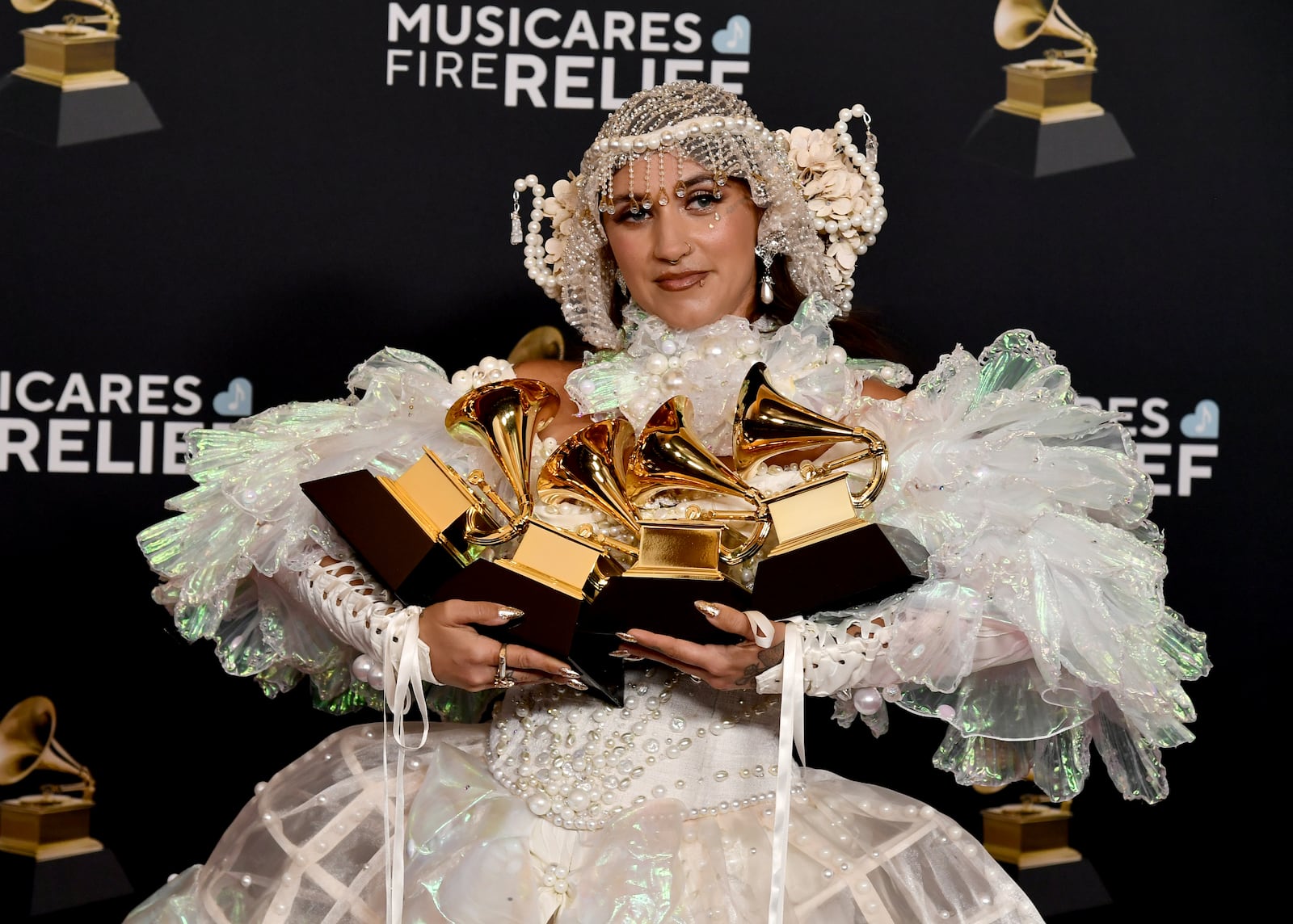 Sierra Ferrell poses in the press room with her awards for best American roots performance, best American roots song, best Americana performance and best Americana album during the 67th annual Grammy Awards on Sunday, Feb. 2, 2025, in Los Angeles. (Photo by Richard Shotwell/Invision/AP)