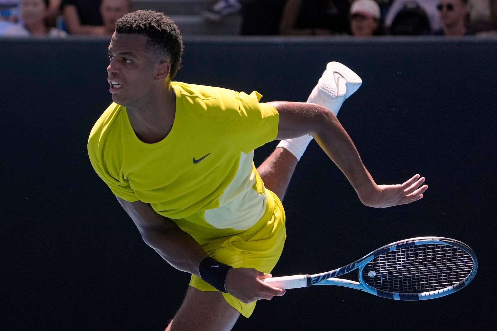 Giovanni Mpetshi Perricard of France serves to compatriot Gael Monfils during their first round match at the Australian Open tennis championship in Melbourne, Australia, Tuesday, Jan. 14, 2025. (AP Photo/Asanka Brendon Ratnayake)