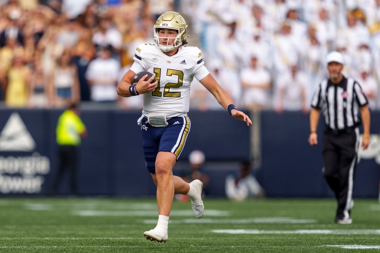 Georgia Tech quarterback Aaron Philo (12) runs during the first half of an NCAA college football game against Miami, Saturday, Nov. 9, 2024, in Atlanta. (AP Photo/Jason Allen)