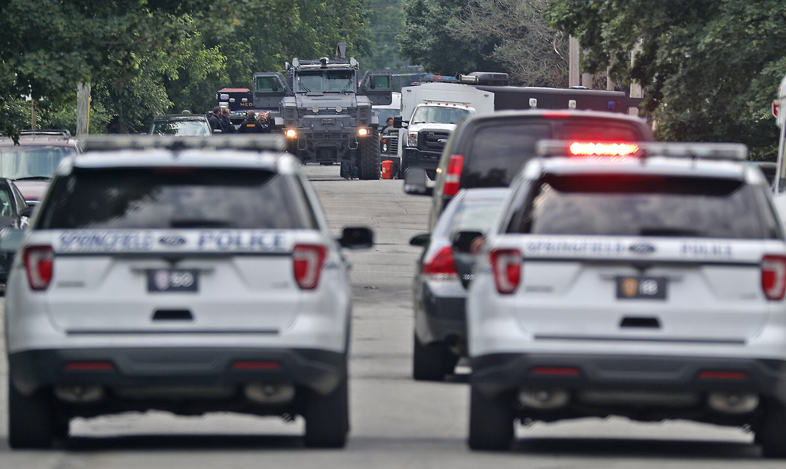 Members of the Springfield Police Division and other law enforcement agencies surround a house at the intersection of South Lowry Avenue and Fair Street Monday, June 6, 2022. The police fired tear gas into the residents and demanded that the man inside come out with his hands up. BILL LACKEY/STAFF