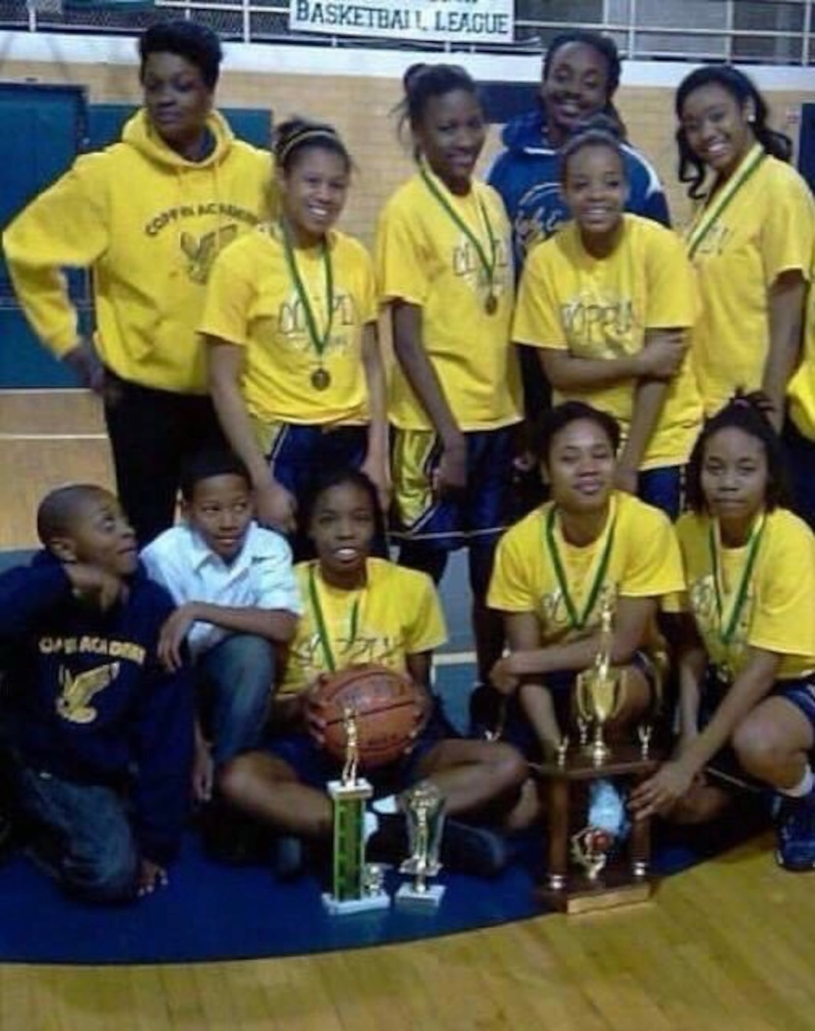 RJ Blakney (bottom row left) looks up at mom, Dwuana “Dafne” Lee Blakney, coach of Coppin Academy High in Baltimore (top row left). CONTRIBUTED