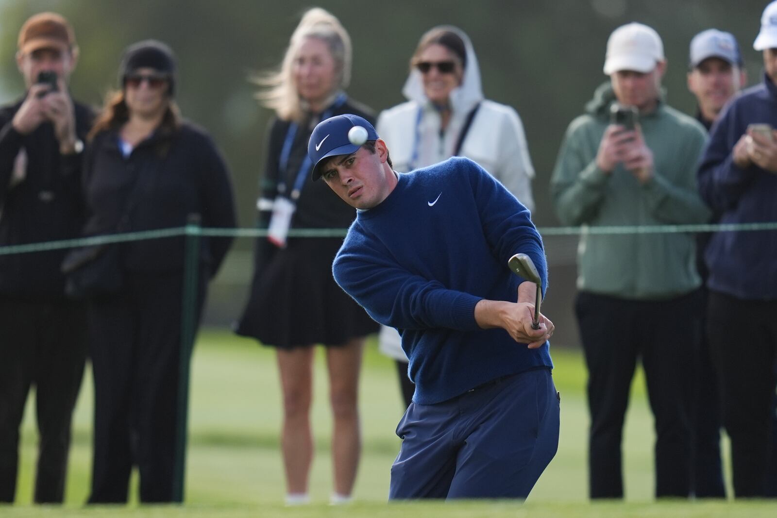 Davis Thompson hits a shot onto the 15th green of the South Course at Torrey Pines during the second round of the Genesis Invitational golf tournament Friday, Feb. 14, 2025, in San Diego. (AP Photo/Gregory Bull)