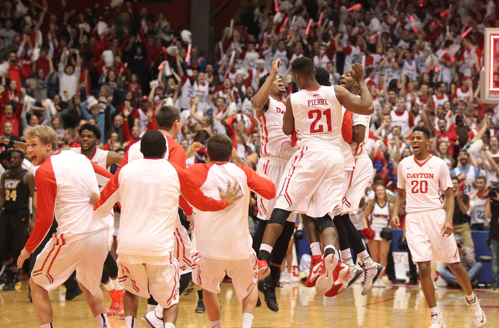 Dayton players celebrate after a victory against Virginia Commonwealth on Saturday, March 5, 20126, at UD Arena in Dayton. David Jablonski/Staff