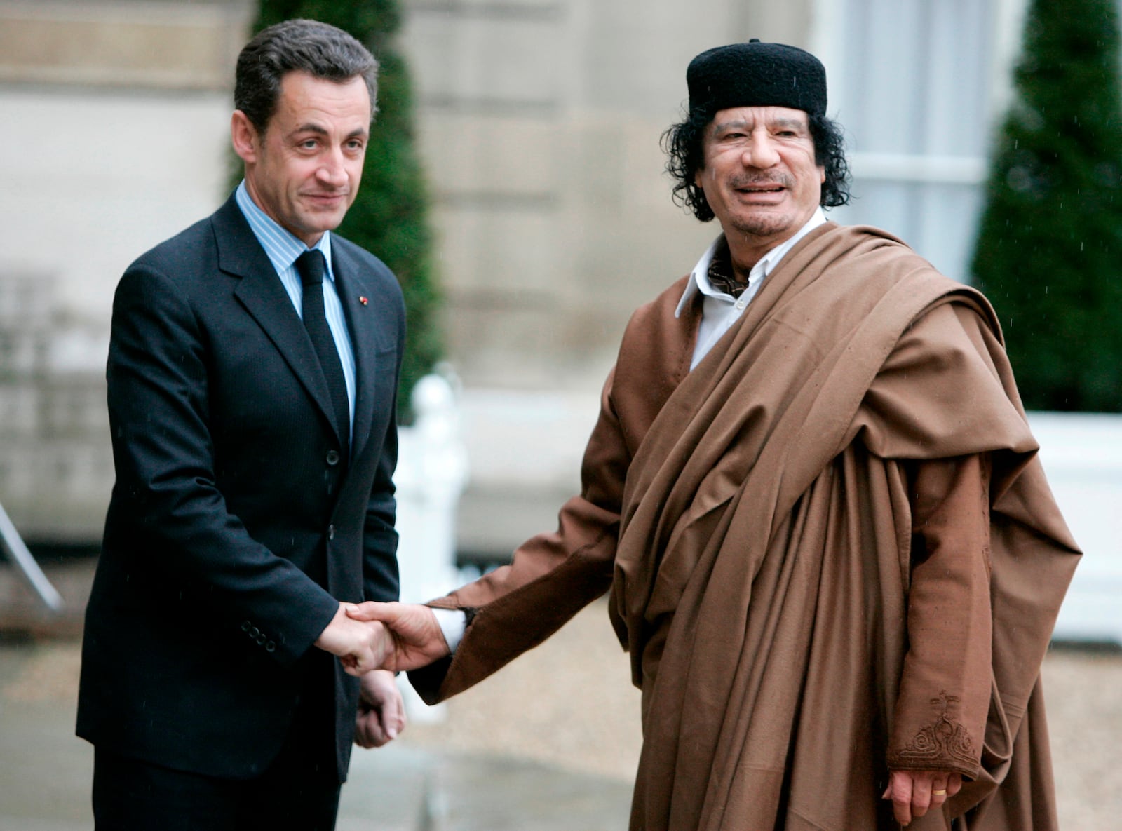 FILE - French President Nicolas Sarkozy, left, greets Libyan leader Col. Moammar Gadhafi upon his arrival at the Elysee Palace, Dec. 10 2007 in Paris. France's former President Nicolas Sarkozy goes on trial Monday Jan.6, 2025 over alleged illegal financing of his 2007 presidential campaign by the government of late Libyan leader Moammar Gadhafi. (AP Photo/Francois Mori, File)