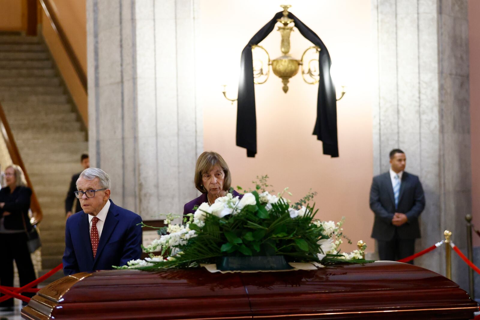 Ohio governor Mike DeWine, left, and his wife Fran pass the the casket for former Ohio House speaker Jo Ann Davidson as it lie in state in the rotunda of the Ohio Sate House in Columbus, Ohio, Thursday, Oct. 31, 2024. (AP Photo/Paul Vernon)