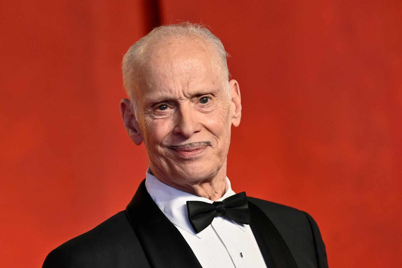 John Waters arrives at the Vanity Fair Oscar Party on Sunday, March 10, 2024, at the Wallis Annenberg Center for the Performing Arts in Beverly Hills, Calif. (Photo by Evan Agostini/Invision/AP)