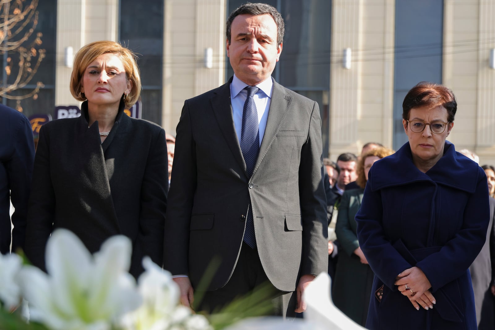 Mimoza Kusari-Lila, left, head of Vetevendosje! Parliamentary group, Kosovo's Prime Minister Albin Kurti, and Donika Gervalla-Schwarz, Kosovo's Foreign Minister, stand at Mother Teresa's square in Pristina, Kosovo, Monday, Feb. 10, 2025. (AP Photo/Vlasov Sulaj)