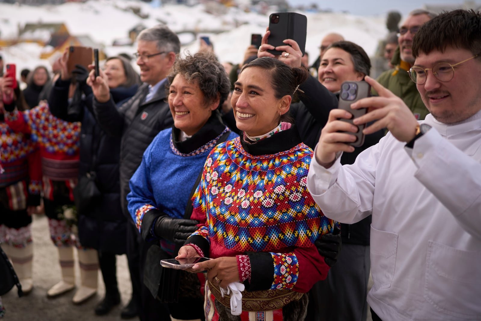 Relatives and friends react as Salik Schmidt and Malu Schmidt wave from the Church of our Savior after getting married in Nuuk, Greenland, Saturday, Feb. 15, 2025. (AP Photo/Emilio Morenatti)