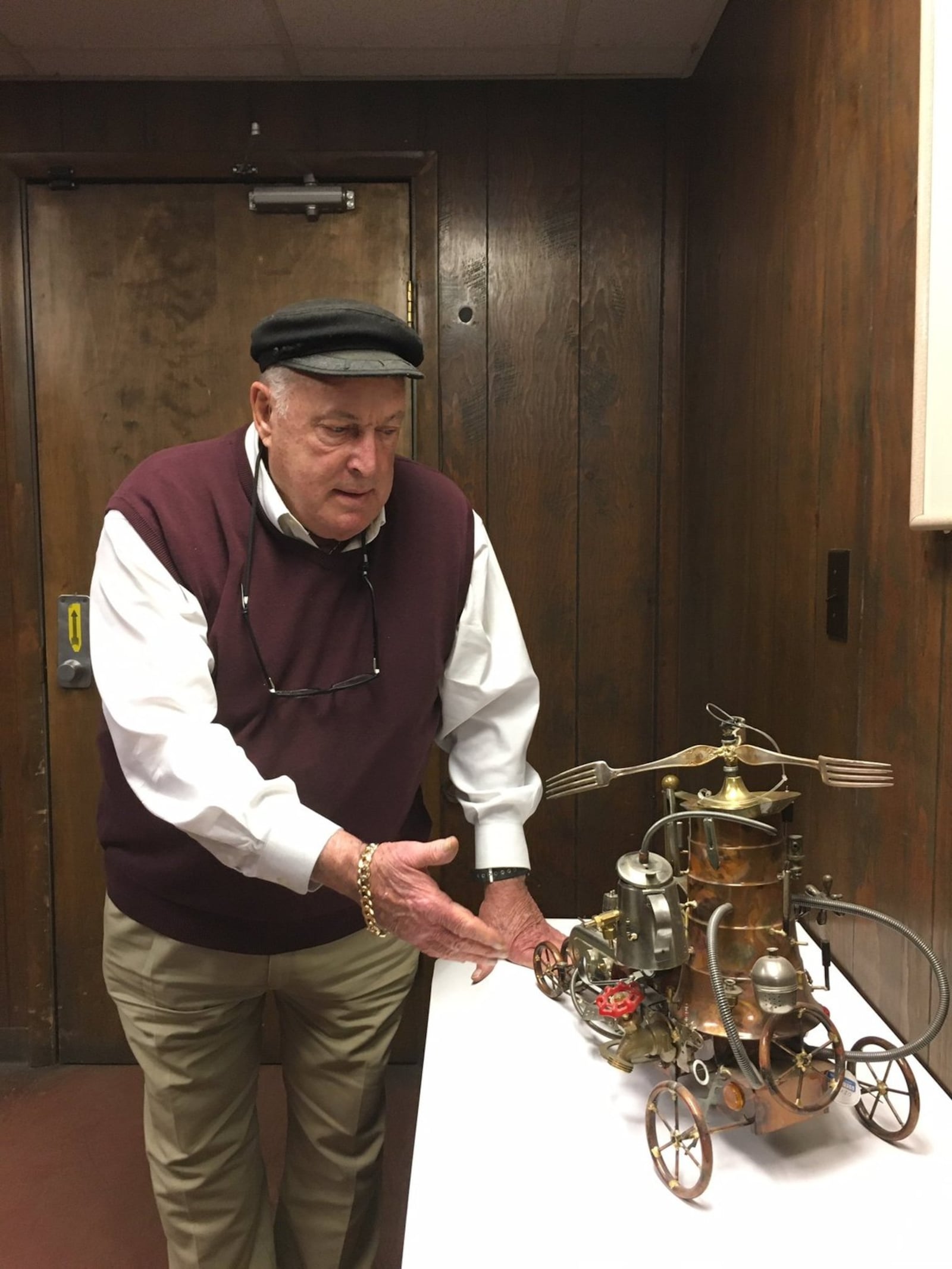 Sandy Mendelson shows off a sculpture entirely made with items from his liquidation outlet. MEREDITH MOSS/STAFF