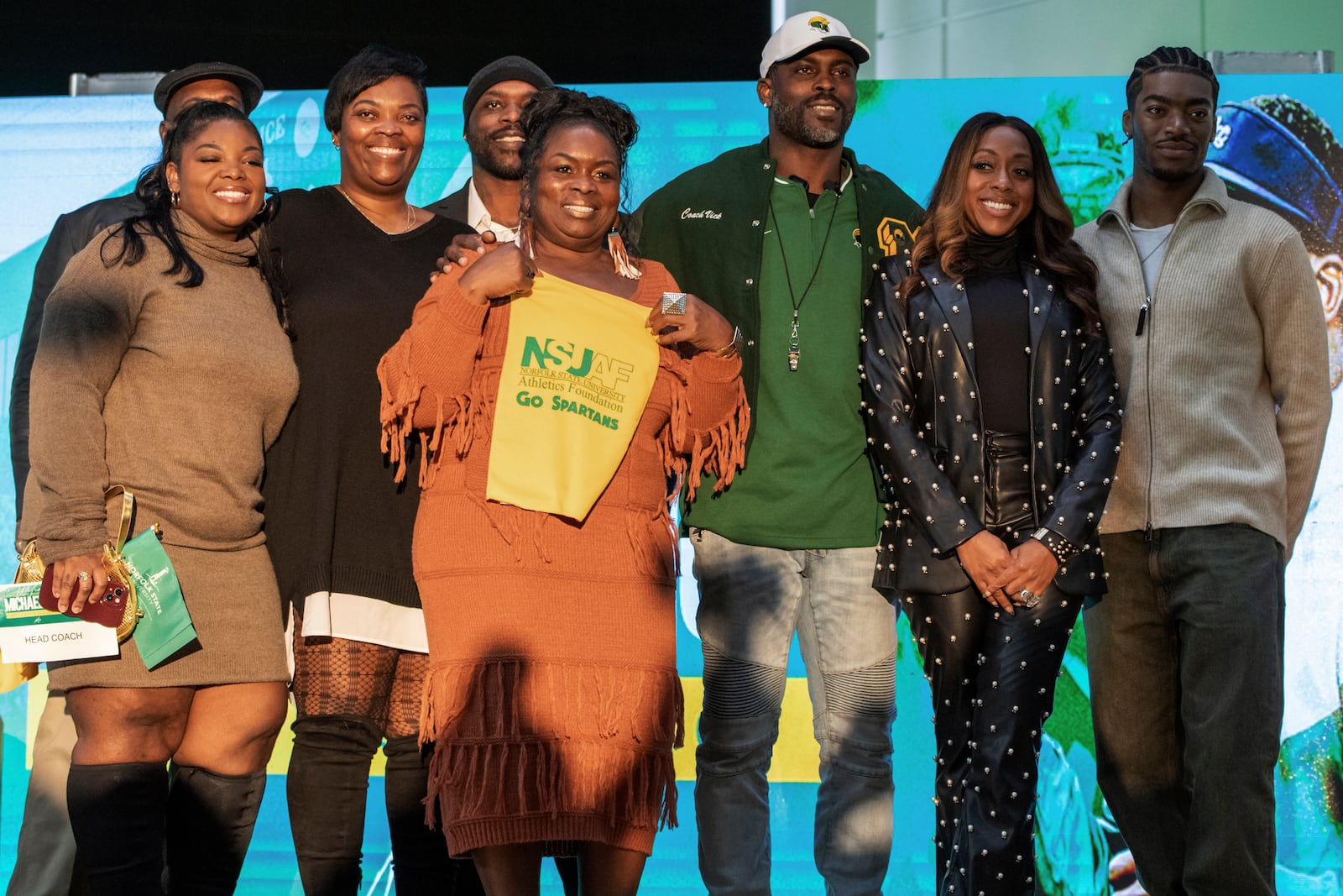 Michael Vick takes a photo with family after being named the next head football coach of Norfolk State University during a press conference on Monday, Dec. 23, 2024 in Norfolk, Va. (AP Photo/Mike Caudill)