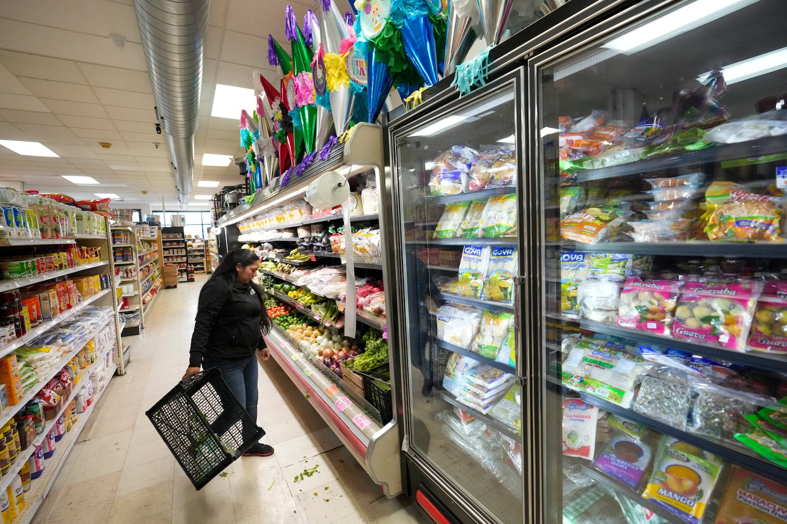 Cristina Cabrera works at El Mexicano grocery store in Worthington, Minnesota. Saturday, Jan. 11, 2025. Cabrera said she migrated to the U.S. three years ago from Guatemala's San Marcos department. (AP Photo/Abbie Parr)