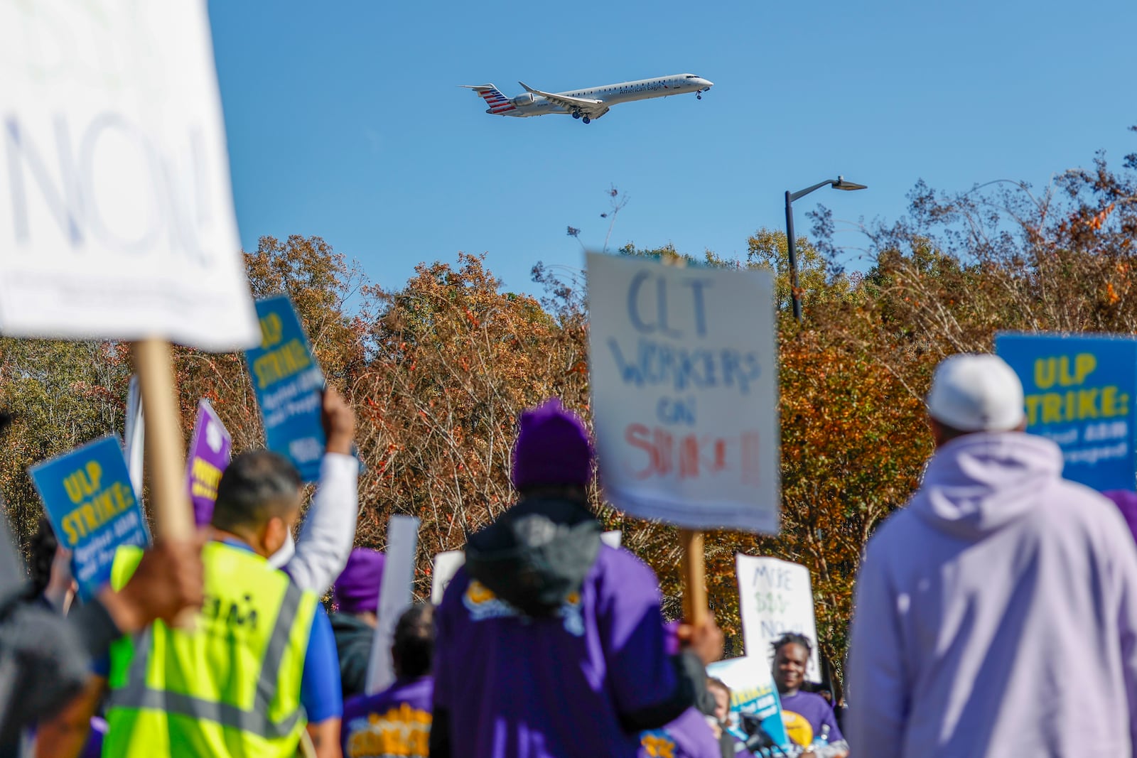 An airplane arrives at Charlotte Douglas International Airport as airport workers strike in front of the Charlotte Douglas International Airport in Charlotte, N.C., Monday, Nov. 25, 2024. (AP Photo/Nell Redmond)