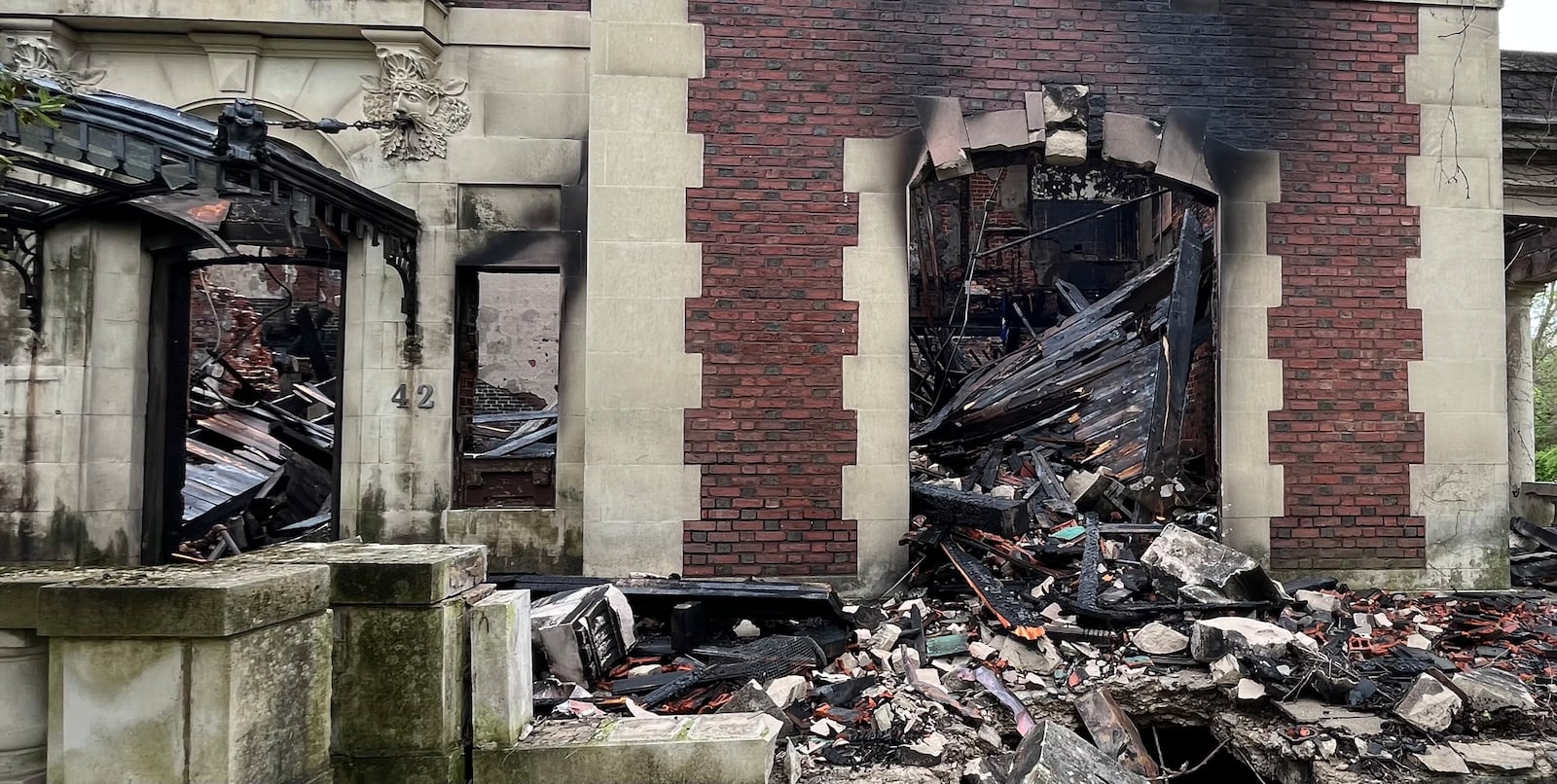 Debris, including parts of the roof, can be seen inside the Traxler Mansion, which was badly damaged by fire at the corner of Broadway and Yale in West Dayton  on Sunday, April 23, 2023. JEREMY P. KELLEY / STAFF