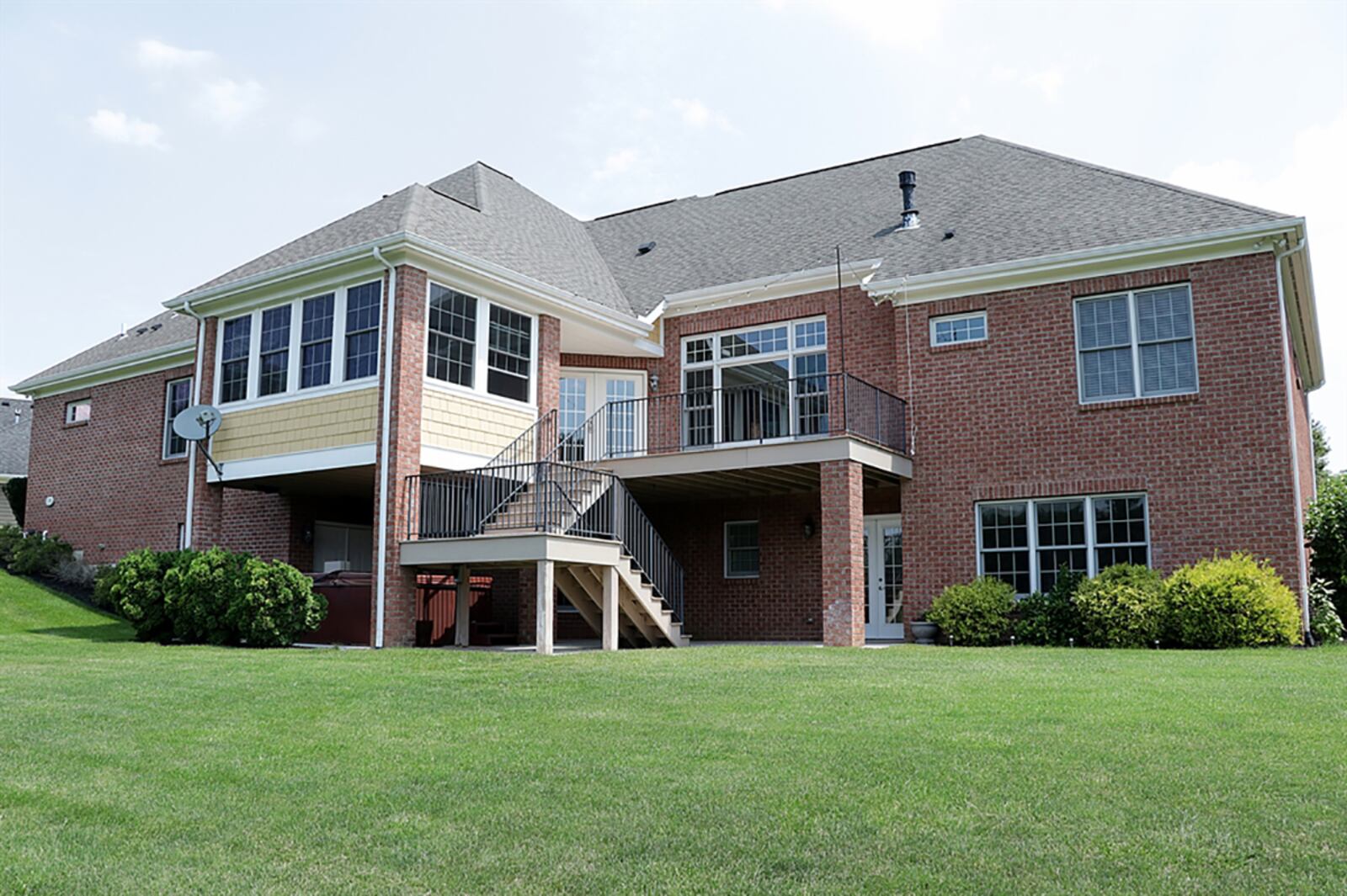 The ranch has views of the nearby countryside and has multi-level outdoor entertainment areas, including a concrete patio part of which is covered, a hot tub area, a composite balcony deck and a 3-season screen-enclosed porch with ceiling paddle fan and deck entrance. CONTRIBUTED PHOTO BY KATHY TYLER