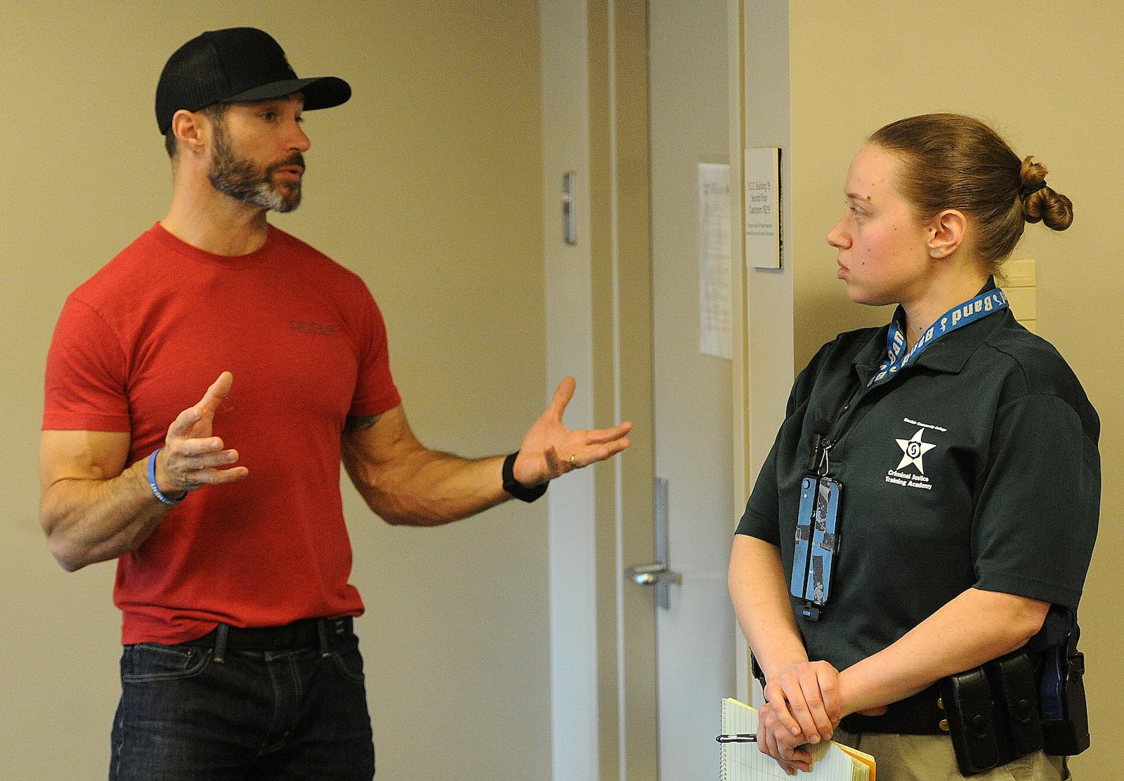 Sgt. Michael Molchan of the Trotwood Police Department gives notes to reporter London Bishop on a crisis intervention scenario, March 3, 2024. MARSHALL GORBY/STAFF