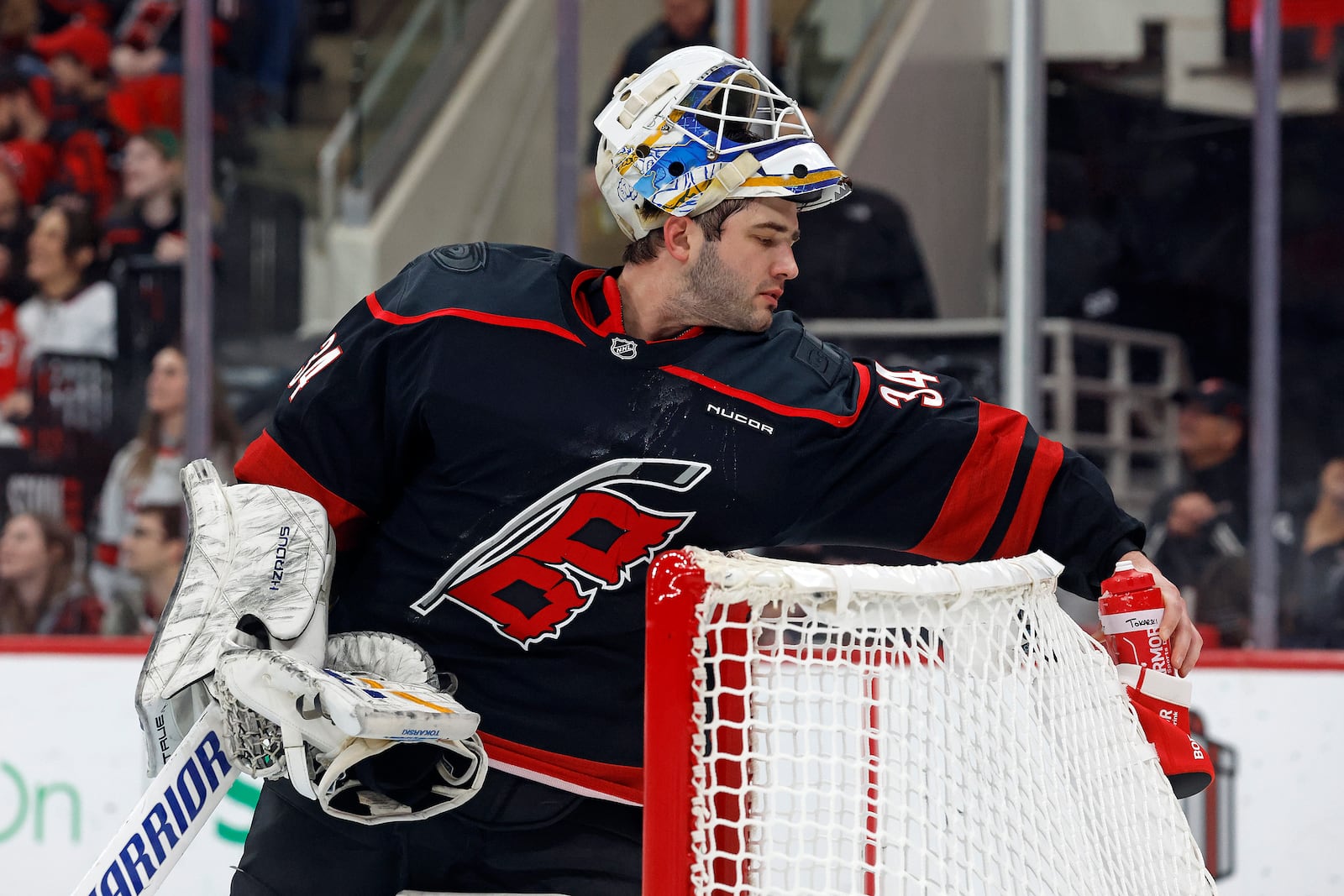 Carolina Hurricanes goaltender Dustin Tokarski (34) gets a drink during the first period of an NHL hockey game against the Columbus Blue Jackets in Raleigh, N.C., Sunday, Dec. 15, 2024. (AP Photo/Karl B DeBlaker)