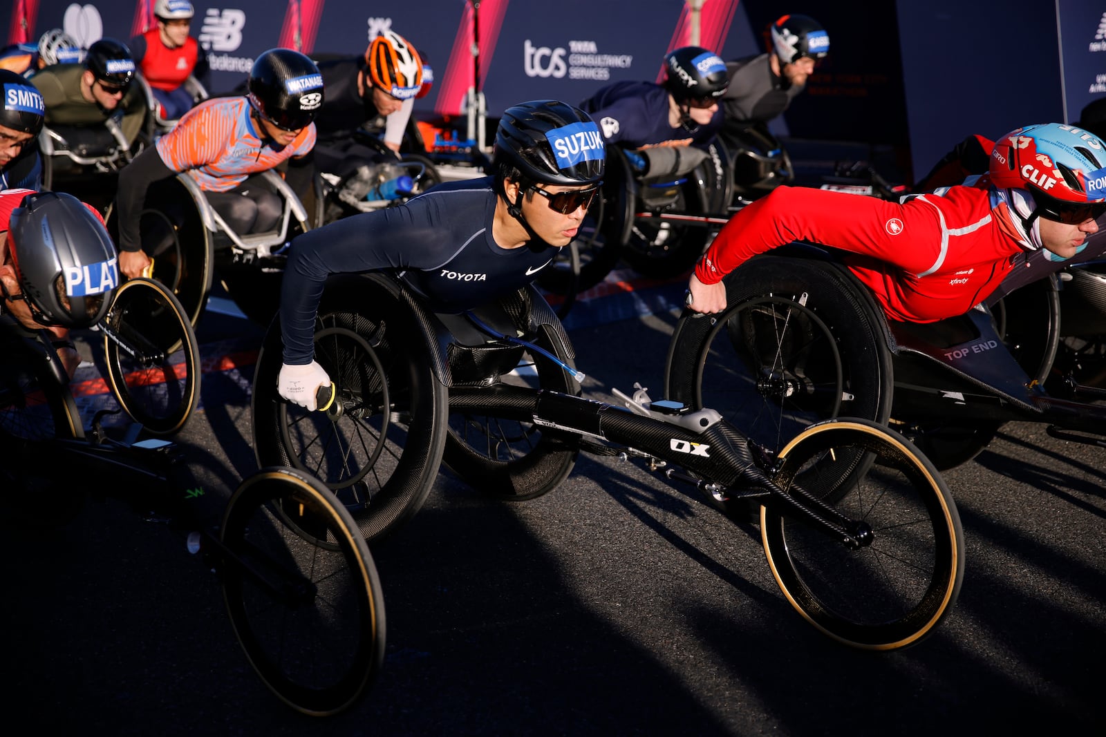 Tomoki Suzuki, center, of Japan, pushes off at the start of men's wheelchair dividing during the New York City Marathon, Sunday, Nov. 3, 2024, in New York. (AP Photo/Eduardo Munoz Alvarez)