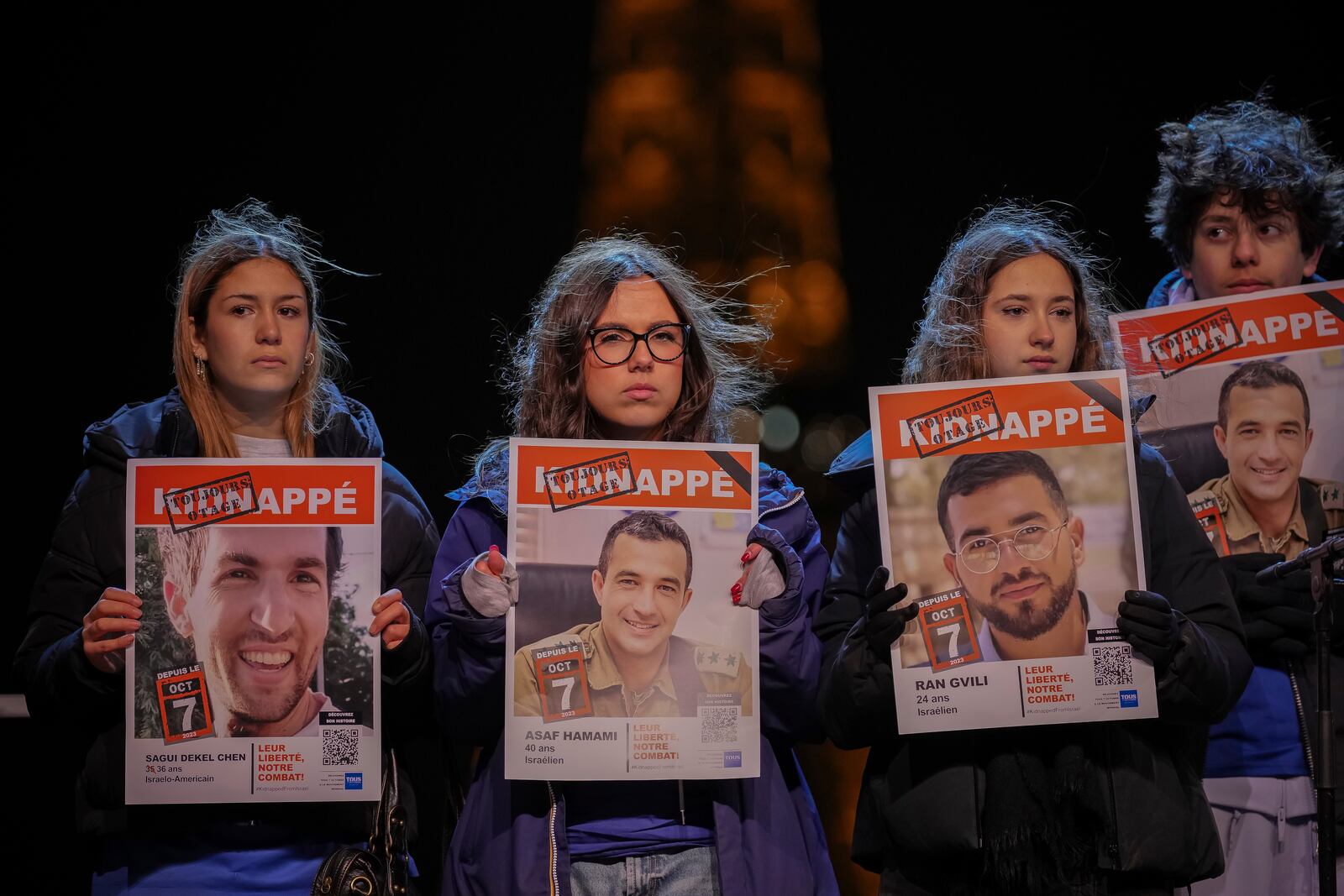 People hold hostages' portraits on stage during a rally in support to the hostages held in the Gaza Strip since Hamas' Oct. 7, 2023 attack on Israel, in Paris, France, Saturday, Sept. 18, 2025. (AP Photo/Aurelien Morissard)