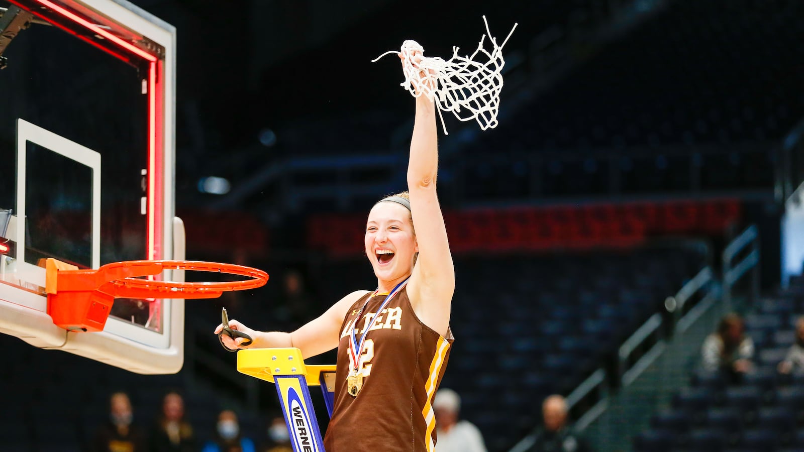 Alter High School senior Karlie Romer celebrates after cutting down the net after the Knights beat Thornville Sheridan 54-38 to win the Division II state championship on Saturday afternoon at UD Arena. CONTRIBUTED PHOTO BY MICHAEL COOPER