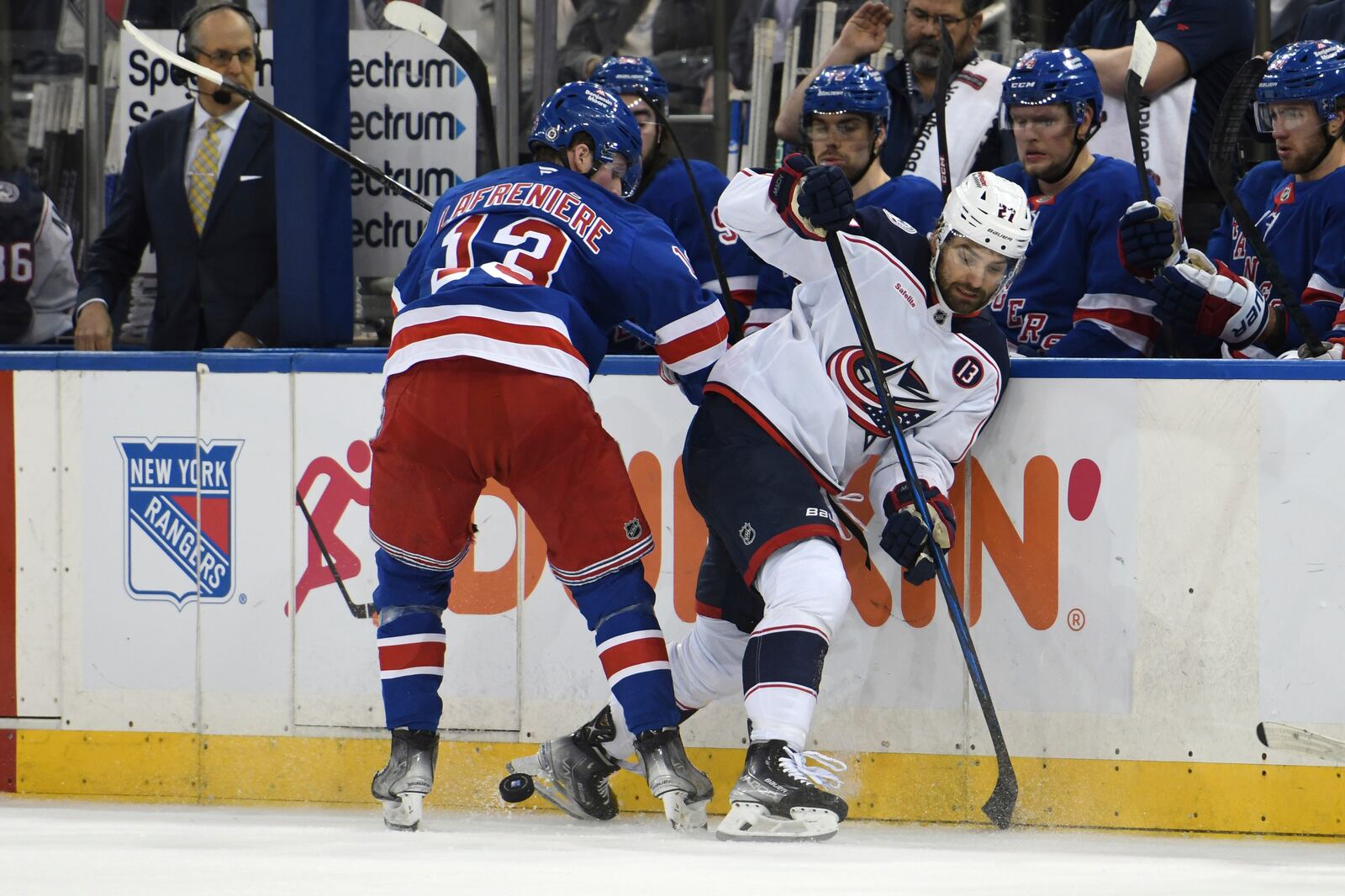 New York Rangers' Alexis Lafrenière, left, and Columbus Blue Jackets' Zachary Aston-Reese, right, fight for the puck during the first period of an NHL hockey game Saturday, Jan. 18, 2025, in New York. (AP Photo/Pamela Smith)