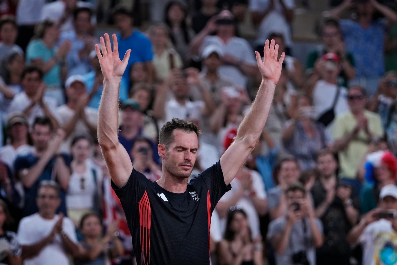 FILE - Andy Murray of Britain cries and waves to the spectators after he and his partner Daniel Evans defeated by Taylor Fritz and Tommy Paul of the United States in the men's doubles quarterfinals tennis match, at the 2024 Summer Olympics, Thursday, Aug. 1, 2024, at the Roland Garros stadium in Paris, France. (AP Photo/Andy Wong, File)