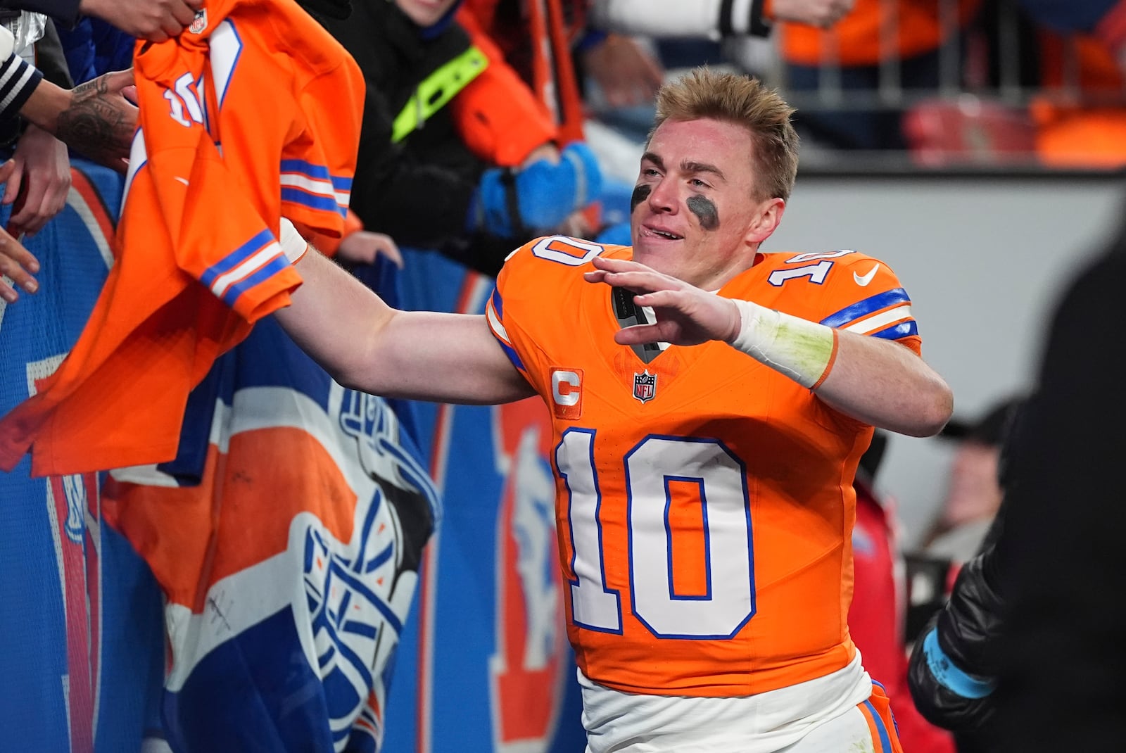 Fans congratulate Denver Broncos quarterback Bo Nix after an NFL football game against the Kansas City Chiefs, Sunday, Jan. 5, 2025, in Denver. (AP Photo/David Zalubowski)