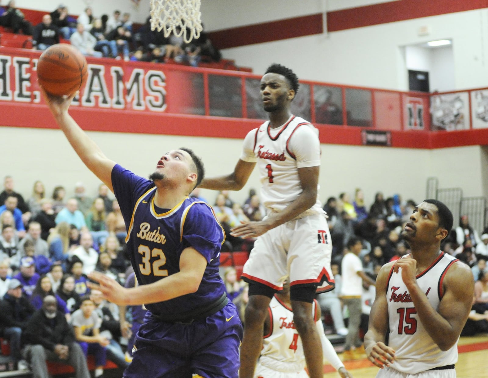 Butler’s Quentin Glover (left) avoids Trotwood-Madison defenders Amari Davis (1) and Justin Stephens. Trotwood defeated visiting Butler 94-76 in a boys high school basketball game on Friday, Jan. 11, 2019. MARC PENDLETON / STAFF