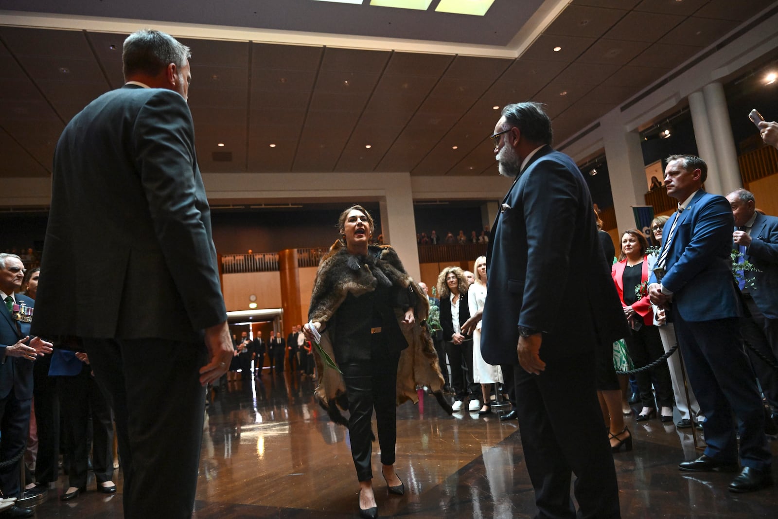 Australian Senator Lidia Thorpe, center, disrupts proceedings as Britain's King Charles III and Queen Camilla attend a Parliamentary reception hosted by Australian Prime Minister Anthony Albanese and partner Jodie Jaydon at Parliament House in Canberra, Australia, Monday, Oct. 21, 2024. (Lukas Coch/Pool Photo via AP)