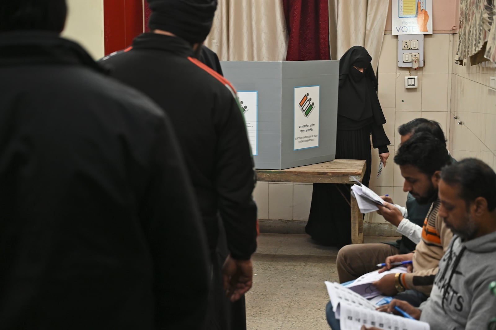 A Muslim woman returns after casting her vote for Delhi state election at a polling booth in New Delhi, India, Wednesday, Feb.5, 2025. (AP Photo)