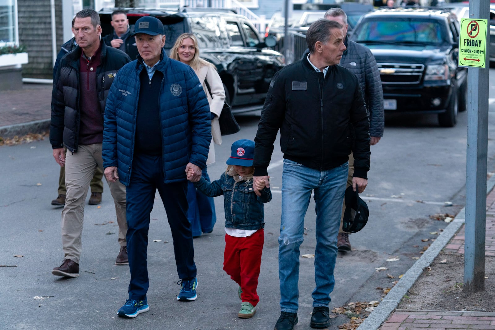 President Joe Biden, from front left, accompanied by his grandson Beau, son Hunter Biden, and daughter-in-law Melissa Cohen Biden, background center, walk in downtown Nantucket, Mass., Friday, Nov. 29, 2024. (AP Photo/Jose Luis Magana)