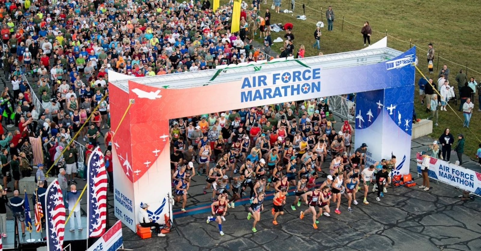 Full and half marathon runners pour through the starting line of the 27th annual Air Force Marathon on Sept. 16, 2023, near the National Museum of the U.S. Air Force, Wright-Patterson Air Force Base. More than 8,500 runners and 1,500 volunteers from all 50 states and 18 countries participated in the event. (U.S. Air Force photo by Jaima Fogg)