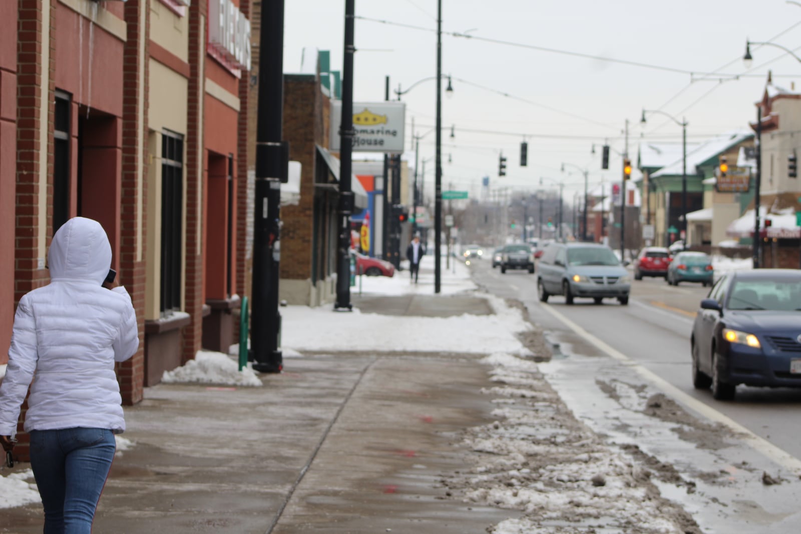 A young woman walked along Brown Street, which is home to several businesses that this year were approved for Paycheck Protection Program loans to help retain employees. CORNELIUS FROLIK / STAFF